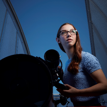 Kirsten Banks with a telescope