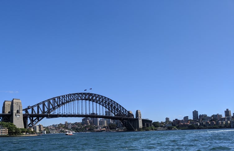 Sydney Harbor Bridge infront for a bright blue sky